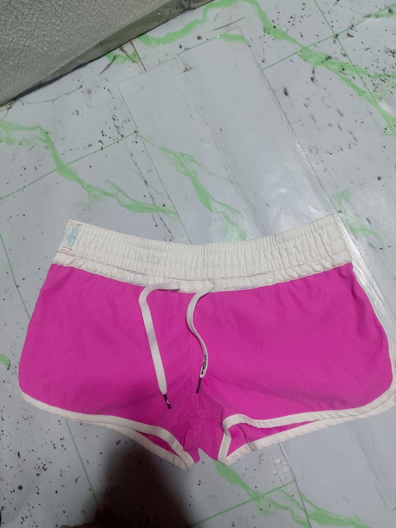 Roxy pink boardshorts size 8 with sparkly logo (Category: Shorts) located in Antipolo. Submitted by y2k_outfitters. (Listing ID 1469516612, Image 2). Description: - Brand: Roxy - Style: Y2K surf style bright pink boardshorts - Size: Tagged Size 8 - Features: White elastic waistband with drawstring, sparkly silver Roxy script logo on left leg, and small back pocket with grommets - Origin: Made in China.