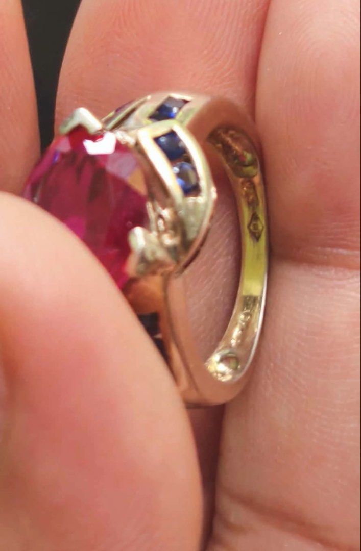 Ruby with Fasceted Blue Sapphire Stones (Category: Rings) located in Cauayan City . Submitted by espiritucj (Listing ID 1469430198, Image 3). Description: Japan Haul Big MM si Ruby stone With markingss- - Gold band cocktail ring - Large oval-cut ruby center - faceted sapphire stones - Hallmarks stamped inside the band - Unique statement piece.