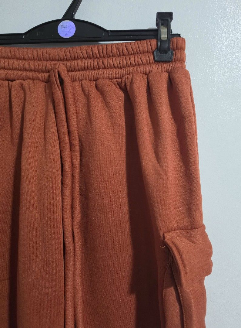 Rust orange crop top and cargo sweatpants set (Category: Sets or Coordinates) located in Paranaque City. Submitted by franinnashop (Listing ID 1469458116, Image 3). Description: Declutter - Style: Matching cargo sweatpants and crop tank set - Color: Rust orange - Material: Super cozy fleece - Pants Features: Functional side pockets, elastic waistband with adjustable drawstring, and cinched cuffs - Tank Features: Wide scoop neckline and ribbed hem