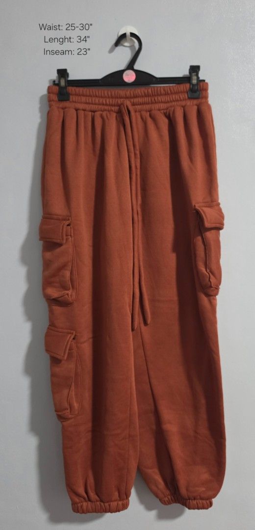 Rust orange crop top and cargo sweatpants set (Category: Sets or Coordinates) located in Paranaque City. Submitted by franinnashop (Listing ID 1469458116, Image 2). Description: Declutter - Style: Matching cargo sweatpants and crop tank set - Color: Rust orange - Material: Super cozy fleece - Pants Features: Functional side pockets, elastic waistband with adjustable drawstring, and cinched cuffs - Tank Features: Wide scoop neckline and ribbed hem