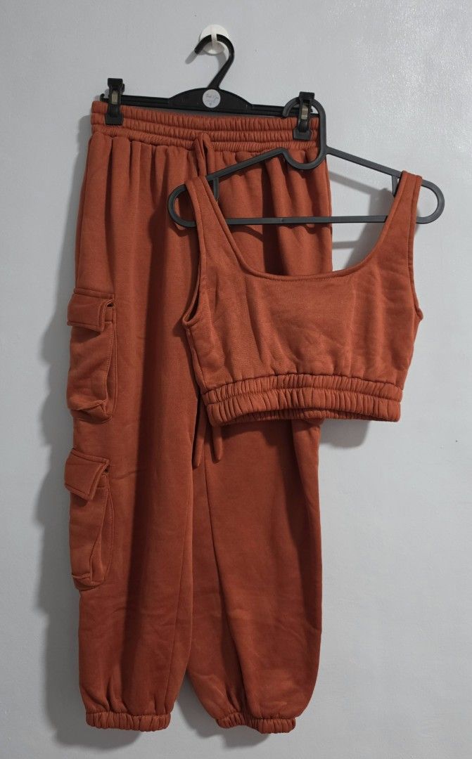 Rust orange crop top and cargo sweatpants set (Category: Sets or Coordinates) located in Paranaque City. Submitted by franinnashop (Listing ID 1469458116, Image 1). Description: Declutter - Style: Matching cargo sweatpants and crop tank set - Color: Rust orange - Material: Super cozy fleece - Pants Features: Functional side pockets, elastic waistband with adjustable drawstring, and cinched cuffs - Tank Features: Wide scoop neckline and ribbed hem