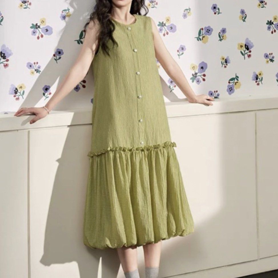 Chartreuse Checkered Sleeveless Balloon Hem Dress (Category: Dresses) located in General Trias. Submitted by dearsunnyshine (Listing ID 1469487149, Image 3). Description: - Color: Sage green with subtle checkered texture - Style: Sleeveless midi dress with drop-waist and voluminous bubble hem - Details: Front button placket with white pearl buttons, adjustable back necktie bow - Fabric: Lightweight woven material, easy slip-on fit - Condition: Br