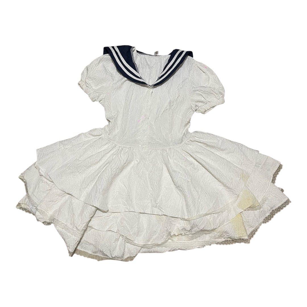 Sailor Dress (Category: Dresses) located in Baguio. Submitted by find_found001 (Listing ID 1469546009, Image 1). Description: Style: Sailor dress / Mini dress · Color: White with Navy trim · Features: Sailor collar, puff sleeves, button-down front, tiered ruffle skirt, lace hem detailing. · Condition: Pre-owned vintage condition. Please note: some slight yellowing near the bottom hem..