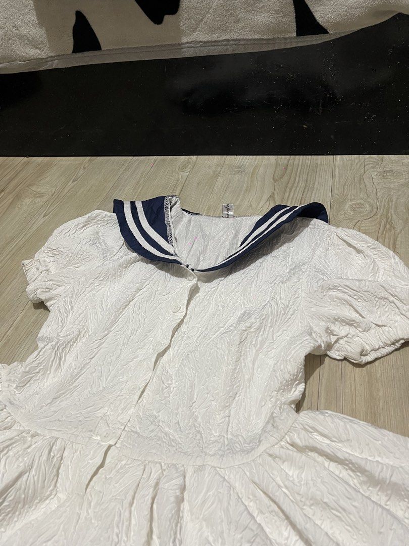 Sailor Dress (Category: Dresses) located in Baguio. Submitted by find_found001 (Listing ID 1469546009, Image 3). Description: Style: Sailor dress / Mini dress · Color: White with Navy trim · Features: Sailor collar, puff sleeves, button-down front, tiered ruffle skirt, lace hem detailing. · Condition: Pre-owned vintage condition. Please note: some slight yellowing near the bottom hem..