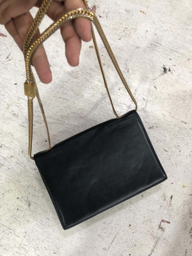 Saint Laurent Black Leather Chain Bag (Category: Luxury Bags & Wallets) located in Bacolod City. Submitted by novymaesel14868 (Listing ID 1469397079, Image 2). Description: - Brand: Saint Laurent - Material: Premium black leather - Hardware: Iconic YSL monogram in mixed gold and silver - Strap: Chain strap featuring an engraved Saint Laurent metal tag - Design: Clean black sides and back profile - Size: Compact, ideal for daily essentials - Condi