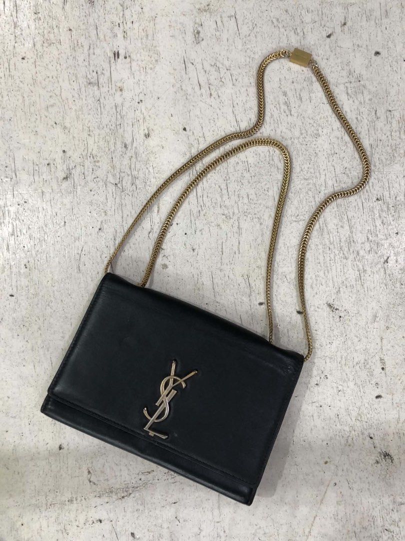 Saint Laurent Black Leather Chain Bag (Category: Luxury Bags & Wallets) located in Bacolod City. Submitted by novymaesel14868 (Listing ID 1469397079, Image 3). Description: - Brand: Saint Laurent - Material: Premium black leather - Hardware: Iconic YSL monogram in mixed gold and silver - Strap: Chain strap featuring an engraved Saint Laurent metal tag - Design: Clean black sides and back profile - Size: Compact, ideal for daily essentials - Condi