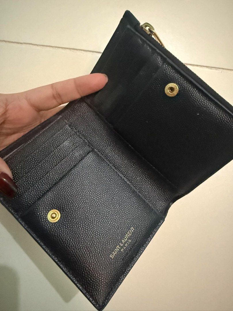 Saint Laurent YSL Monogram Quilted Compact Wallet Black Gold (Category: Luxury Bags & Wallets) located in Quezon City. Submitted by hellopatchi (Listing ID 1469435580, Image 2). Description: - Brand: Saint Laurent - Material: Black grained leather with chevron quilting - Hardware: Gold-tone - Logo: Classic interlocking YSL front logo - Closure: Snap button - Interior: Multiple card slots and compartments - Size: Compact, fits easily in small hand