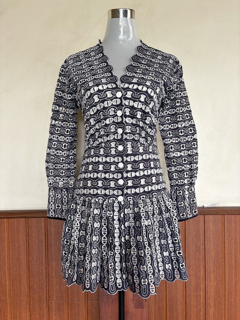 Sandro Navy Blue Chain Eyelet Snap Button Mini Dress (Category: Dresses) located in Cebu City. Submitted by stylingtrends.coll (Listing ID 1469434517, Image 2). Description: - Color: Navy blue and white eyelet embroidered chain pattern - Style: Mini dress with drop waist and flared skirt - Details: Long sleeves, snapbutton-front closure, and charming scalloped trim along the V-neck and hem - Casual dates, brunch, or smart-casual events Size: Smal