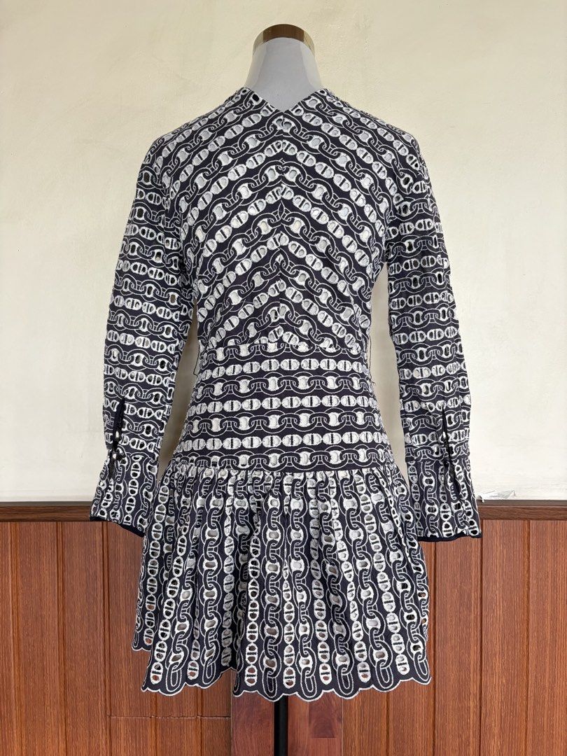 Sandro Navy Blue Chain Eyelet Snap Button Mini Dress (Category: Dresses) located in Cebu City. Submitted by stylingtrends.coll (Listing ID 1469434517, Image 3). Description: - Color: Navy blue and white eyelet embroidered chain pattern - Style: Mini dress with drop waist and flared skirt - Details: Long sleeves, snapbutton-front closure, and charming scalloped trim along the V-neck and hem - Casual dates, brunch, or smart-casual events Size: Smal