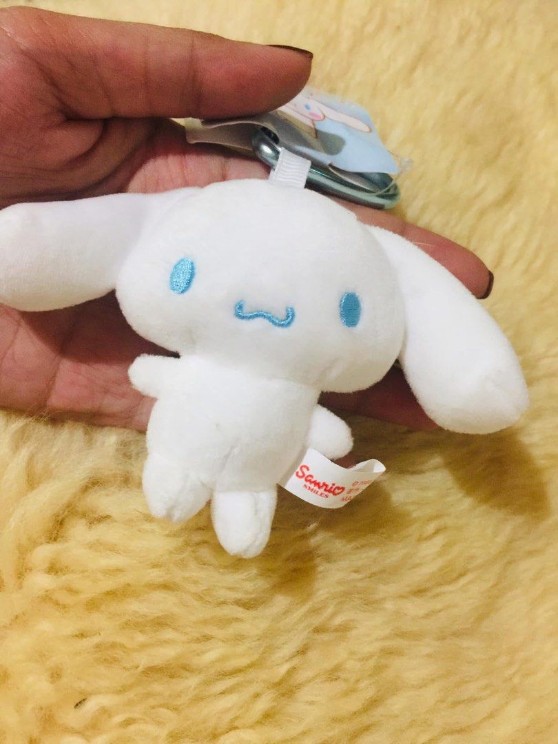 Sanrio Cinnamoroll Mini Mascot Keychain Plush (Category: Plushies & Soft Toys) located in Baguio. Submitted by izza_thrifty (Listing ID 1469567808, Image 2). Description: - Official 2023 Sanrio merchandise - Genuine Cinnamoroll mini plush with blue eyes and mouth embroidery - Equipped with a sturdy metal carabiner clip and ring - Complete with original paper barcode tag and Sanrio Smiles side fabric tag.