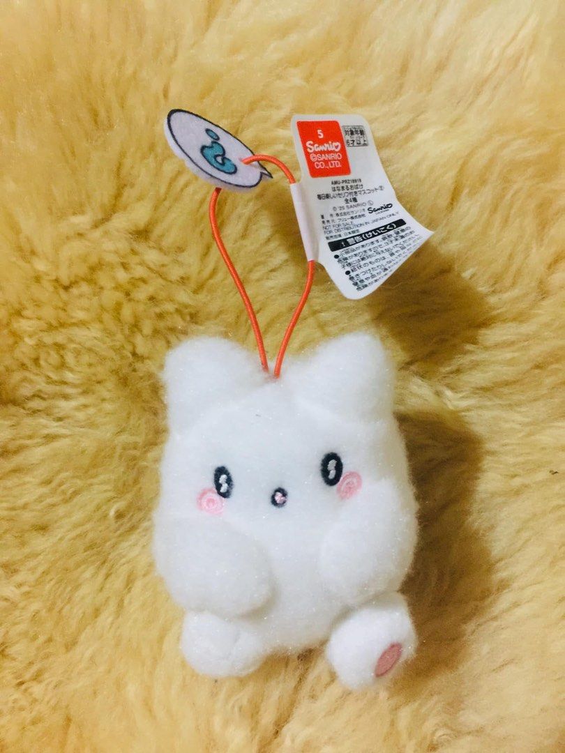 Sanrio Hanamaru Obake Mascot Plush Keychain (Category: Plushies & Soft Toys) located in Baguio. Submitted by izza_thrifty (Listing ID 1469513779, Image 1). Description: - Item: Sanrio Hanamaru Obake Plush Keychain - Condition: Brand new with original tags attached - Design: Embroidered facial details, cute pink cheeks, and orange swirl accent on the back - Details: Includes hanging loop with speech bubble tag - Authenticity: Official Furyu prize 