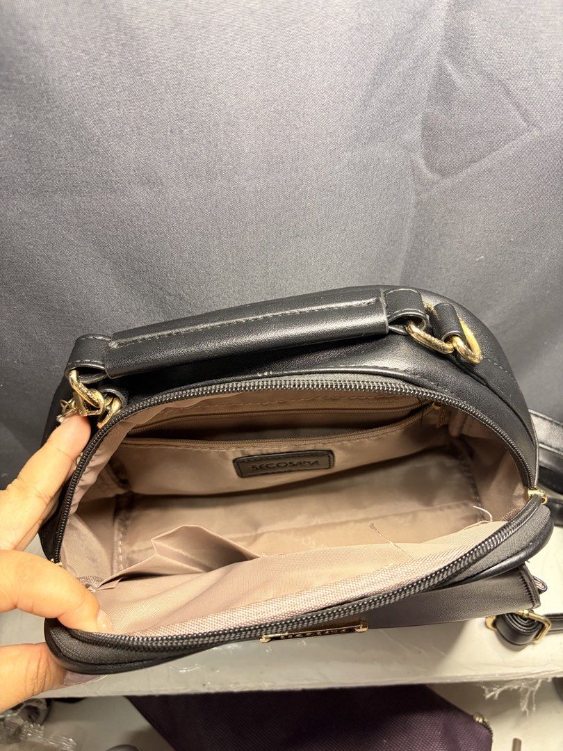 Secosana Black Sling Bag (Category: Cross-body Bags) located in Caloocan City. Submitted by mntnzchsk (Listing ID 1469397810, Image 3). Description: - Brand: Secosana - Color: Classic Black with elegant Gold hardware - Closure: Top zipper and magnetic snap front flap - Pockets: Convenient back pocket, plus internal slip and zipper pockets .