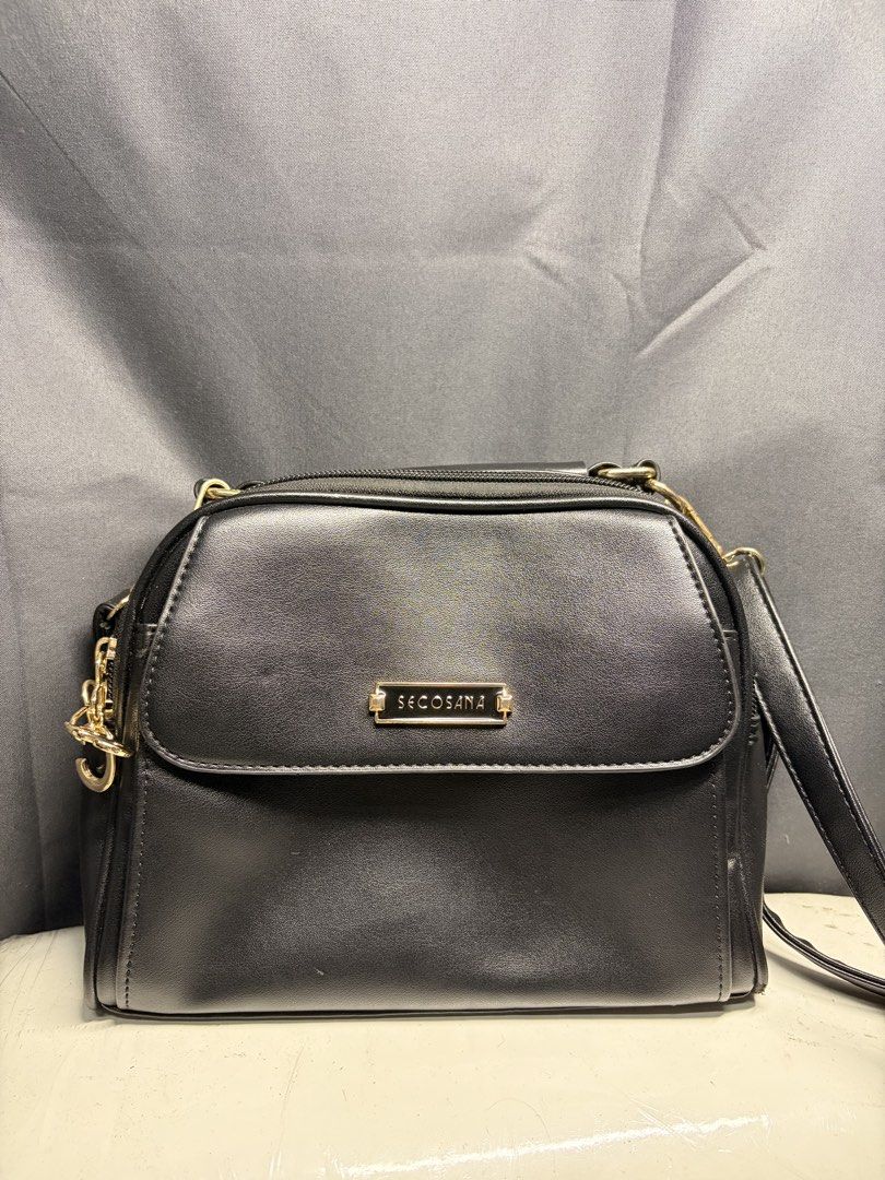 Secosana Black Sling Bag (Category: Cross-body Bags) located in Caloocan City. Submitted by mntnzchsk (Listing ID 1469397810, Image 2). Description: - Brand: Secosana - Color: Classic Black with elegant Gold hardware - Closure: Top zipper and magnetic snap front flap - Pockets: Convenient back pocket, plus internal slip and zipper pockets .