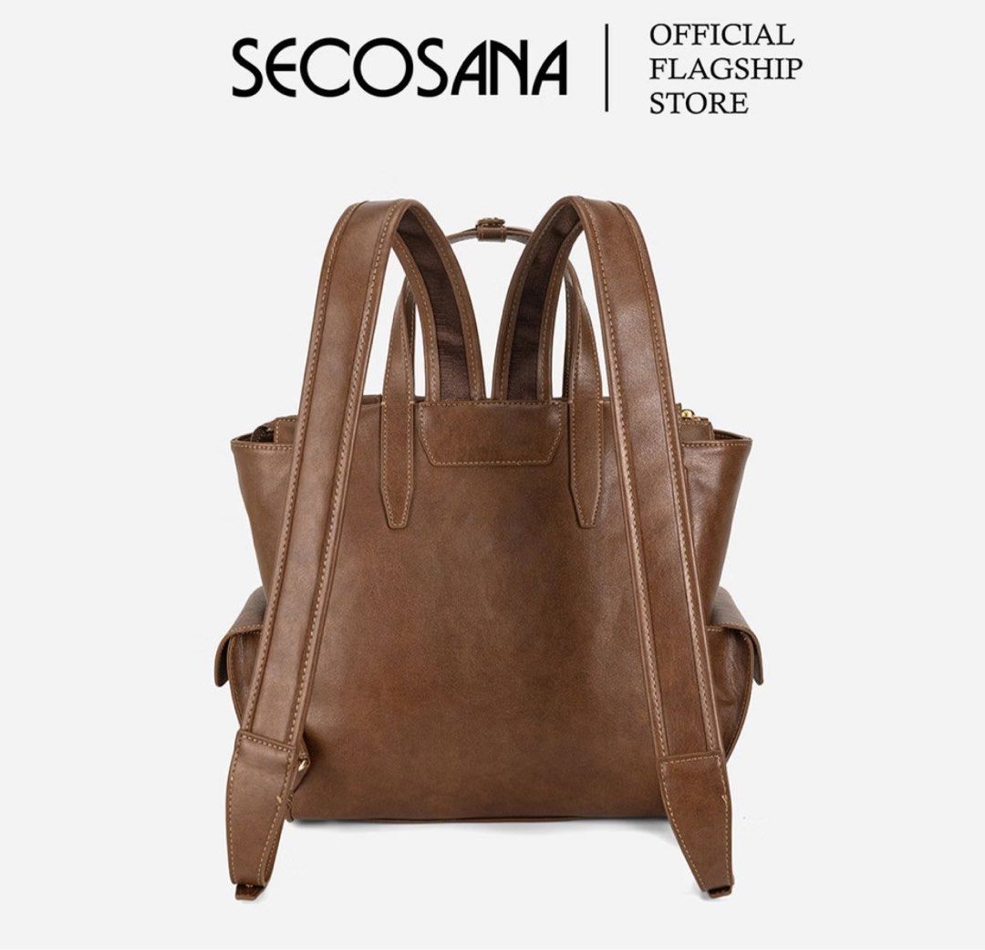 SECOSANA® Leafa Forever Classic Backpack (Category: Backpacks) located in Angeles City. Submitted by forevertrendy (Listing ID 1469427068, Image 2). Description: - Brand: Secosana - Material: Brown synthetic leather - Style: Convertible (use as a backpack or handbag with double top handles) - Closure: Top zip closure for the main compartment - Storage: Roomy interior with a zip pocket and slip-in pocket, plus handy exterior side pockets - Extras: