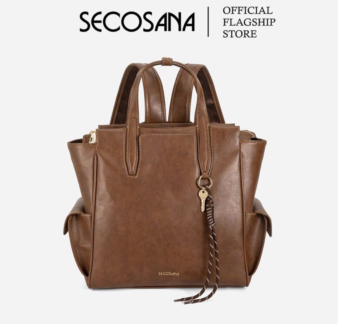 SECOSANA® Leafa Forever Classic Backpack (Category: Backpacks) located in Angeles City. Submitted by forevertrendy (Listing ID 1469427068, Image 1). Description: - Brand: Secosana - Material: Brown synthetic leather - Style: Convertible (use as a backpack or handbag with double top handles) - Closure: Top zip closure for the main compartment - Storage: Roomy interior with a zip pocket and slip-in pocket, plus handy exterior side pockets - Extras: