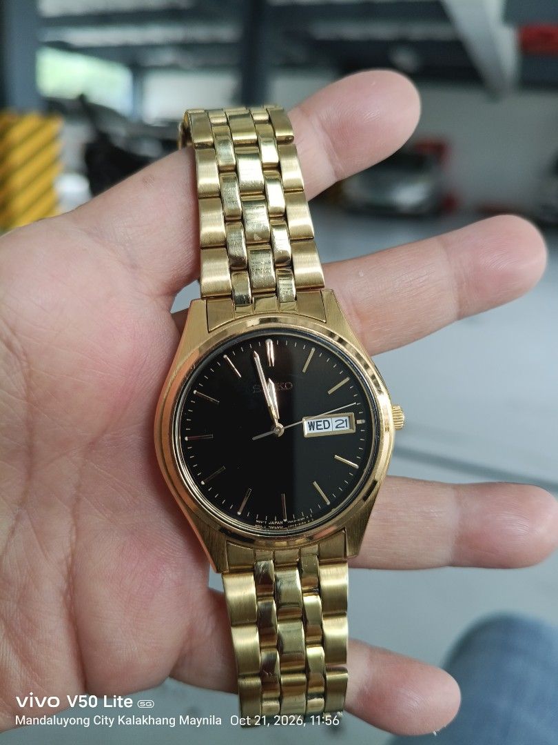 Seiko Gold Tone Quartz Watch Black Dial (Category: Women's Watches) located in Manila. Submitted by prettylook48762 (Listing ID 1469421380, Image 1). Description: - Brand/Model: Seiko Quartz Watch - Colorway: Elegant gold tone with a contrasting black dial - Features: Convenient day-date window at 3 o'clock - Hardware: Stainless steel base metal back with matching gold link bracelet and deployant clasp - Condition: Normal signs of use on the case