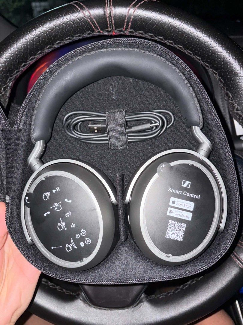 Sennheiser Momentum 4 Wireless Headphones (Category: Headphones & Headsets) located in Sarrat. Submitted by juswah_ (Listing ID 1469396375, Image 2). Description: - Brand: Sennheiser Momentum 4 Wireless - Color: Black - Inclusion 1: Clean fabric hard carry case with centered silver logo - Inclusion 2: Protective case pockets contain audio cable, USB-C charging cable, flight adapter, and manual.