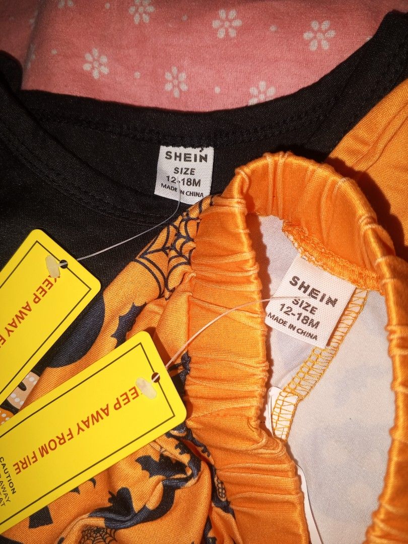 SHEIN Halloween Ghost Romper Pants and Pumpkin Beanie Set (Category: Babies & Kids Fashion) located in Magalang. Submitted by zeiansoria64090 (Listing ID 1469414622, Image 3). Description: - Brand: SHEIN - Condition: Brand new with tags (BNWT) - Size: 12-18 months - Set includes: Black long-sleeve bodysuit ('No Diggity Bout to Bag It Up' ghost graphic), orange trousers (skulls, witch hats, bats, spiderwebs), and a matching pumpkin beanie with jac