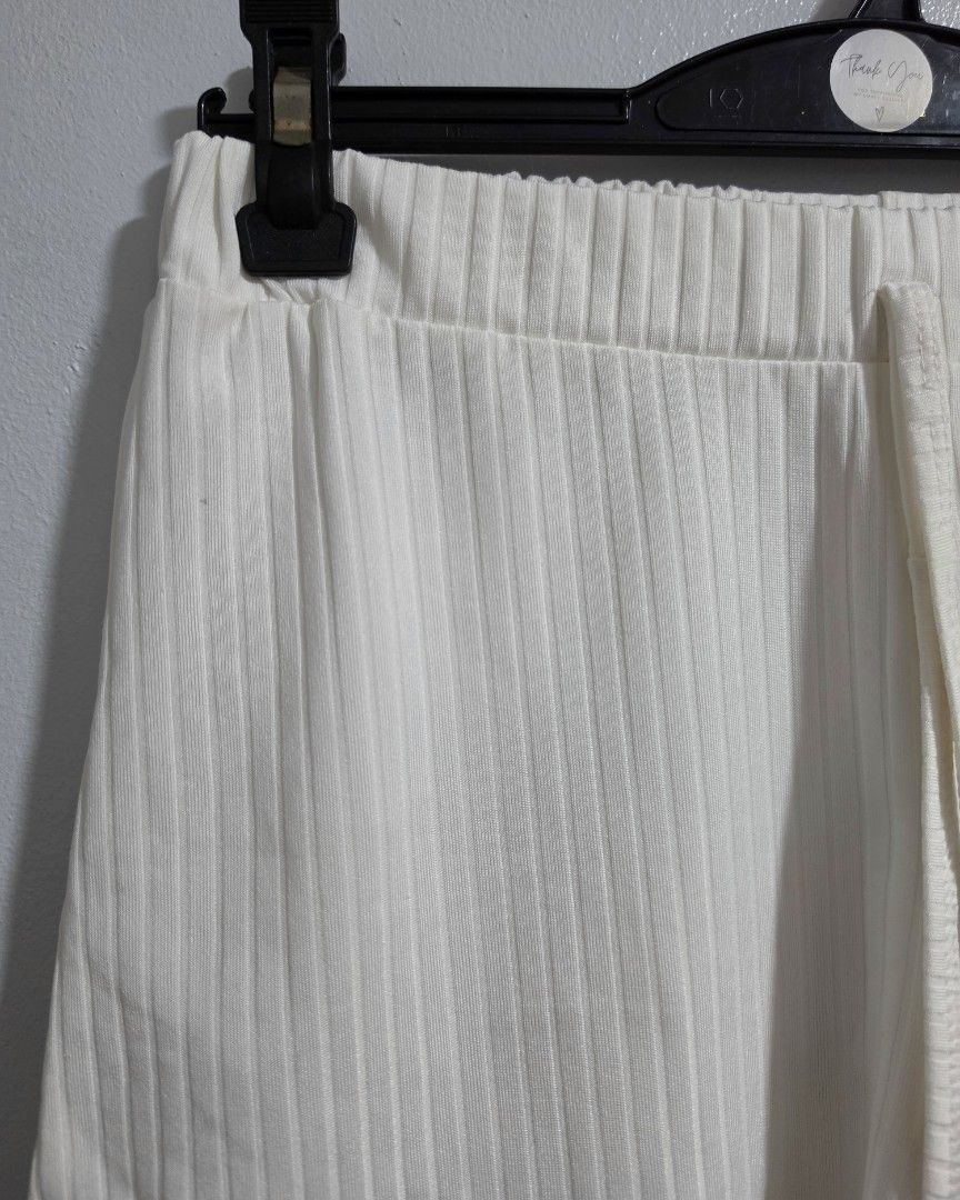 Shein Ribbed White Shorts Size XS (Category: Shorts) located in Paranaque City. Submitted by franinnashop (Listing ID 1469528007, Image 3). Description: declitter - Brand: Shein - Size: XS (EU 34, US 2) - Color: White - Material: Soft ribbed fabric - Waist: 22 to 28 inches (stretchy elastic waistband with drawstring) - Length: 11 inches - Features: Curved hem on the sides - Condition: Clean and well-maintained.