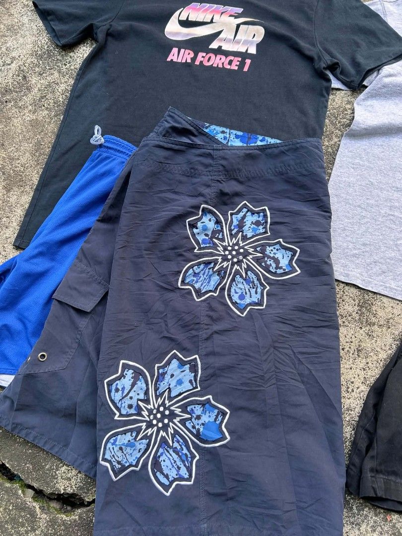 SHORT (Category: Shorts) located in Quezon City. Submitted by jaredalvarr (Listing ID 1469479783, Image 2). Description: - 4-piece bundle of casual tees and swim wear - Includes black Nike Air Force 1 graphic t-shirt - Includes grey Champion t-shirt - Includes dark blue floral board shorts with drawstring - Includes blue and black shorts - Good mix of styles, colors, and sizes - Sold as a set.