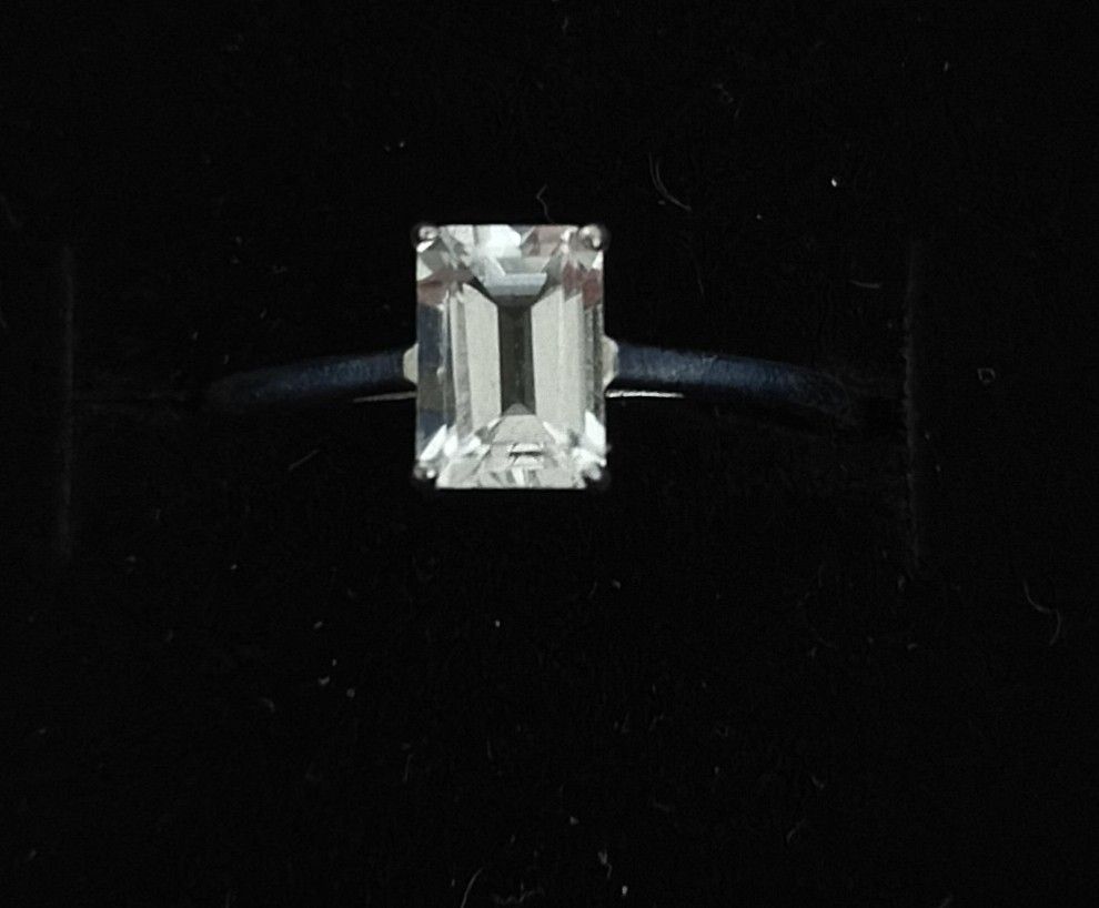 Silver Ring with Emerald Cut White Topaz Solitaire Band (Category: Rings) located in Batangas. Submitted by decluttering_bliss (Listing ID 1469514265, Image 1). Description: - Style: Classic solitaire with a clean finish - Center Stone: Emerald-cut white topaz stone in a secure prong setting - Band: Thin, smooth metal band with side gallery support - Design: Minimalist and elegant profile - Condition: Brand new and high quality.
