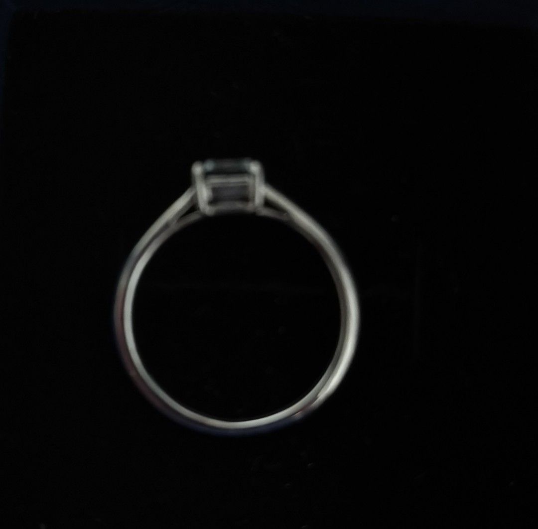 Silver Ring with Emerald Cut White Topaz Solitaire Band (Category: Rings) located in Batangas. Submitted by decluttering_bliss (Listing ID 1469514265, Image 2). Description: - Style: Classic solitaire with a clean finish - Center Stone: Emerald-cut white topaz stone in a secure prong setting - Band: Thin, smooth metal band with side gallery support - Design: Minimalist and elegant profile - Condition: Brand new and high quality.
