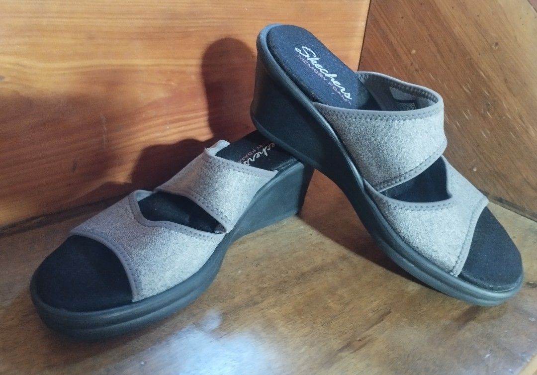 Skechers Memory Foam Wedge Sandals Gray (Category: Wedges) located in Baguio. Submitted by katgon2016 (Listing ID 1469469467, Image 3). Description: - Brand: Skechers - Style: Slip-on open toe wedge sandals with dual top straps - Color: Gray with textured black outsoles - Comfort: Features plush memory foam cushioning for all-day wear - Traction: Good grip on outsoles for safe walking - Condition: Excellent, ideal for casual outings and everyday 