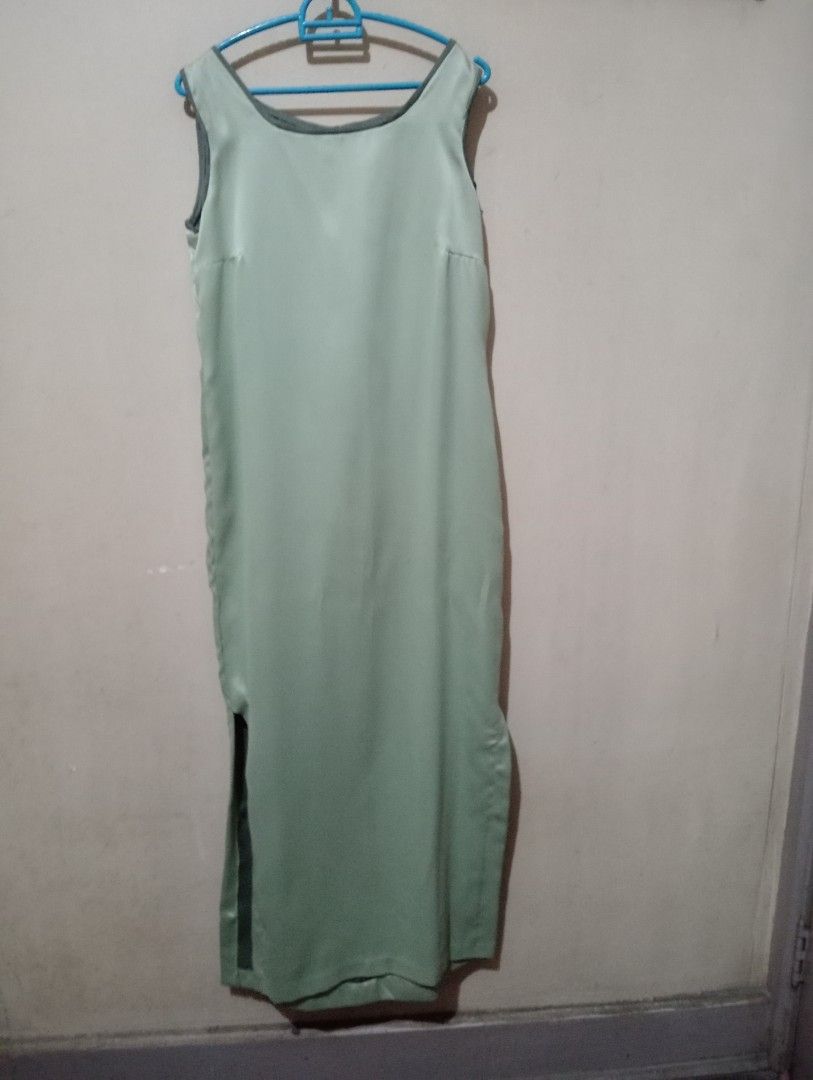 Sleeveless Long Dress with Side Slit (Category: Dresses) located in Makati City. Submitted by YSL80022 (Listing ID 1469527454, Image 1). Description: - Color: Mint green with dark grey contrasting interior lining and trim - Style: Sleeveless scoop neck long dress - Detail: Chic thigh-high side slit on both sides leg exposing the dark lining - Fabric: Smooth material with a subtle, elegant sheen, thick satin - used once during an event - ideal for