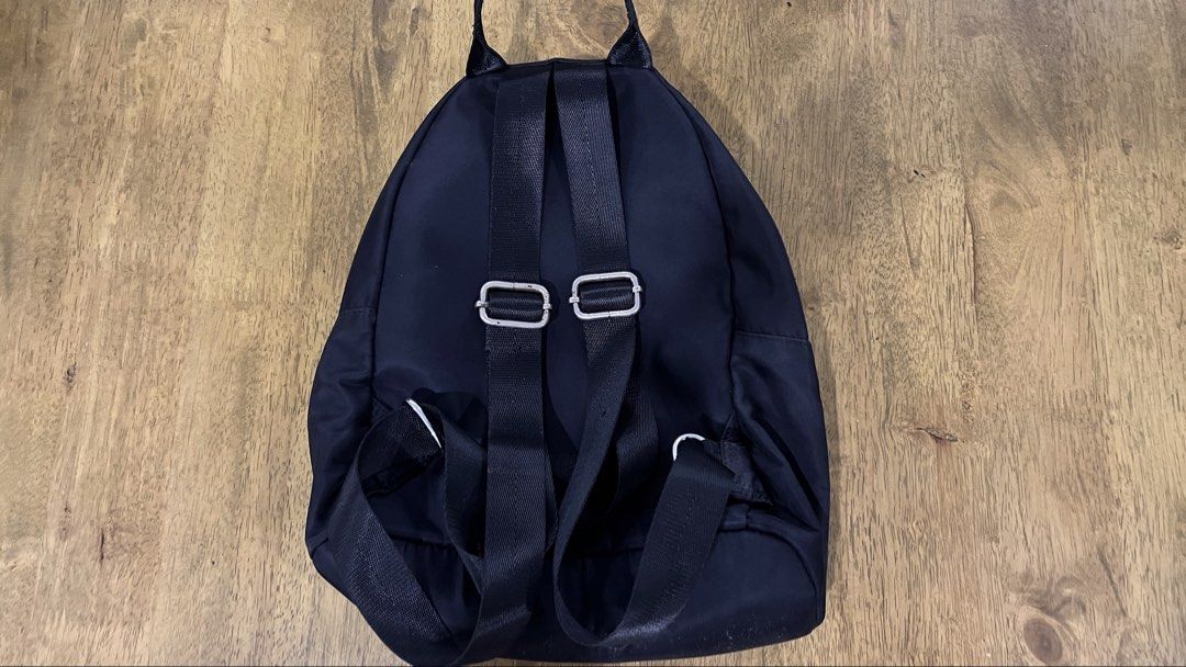 small black backpack (Category: Backpacks) located in San Fernando. Submitted by declutteringyishi (Listing ID 1469492263, Image 2). Description: there are slight stains at the bottom of the bag due to regular use, but still in a good condition..