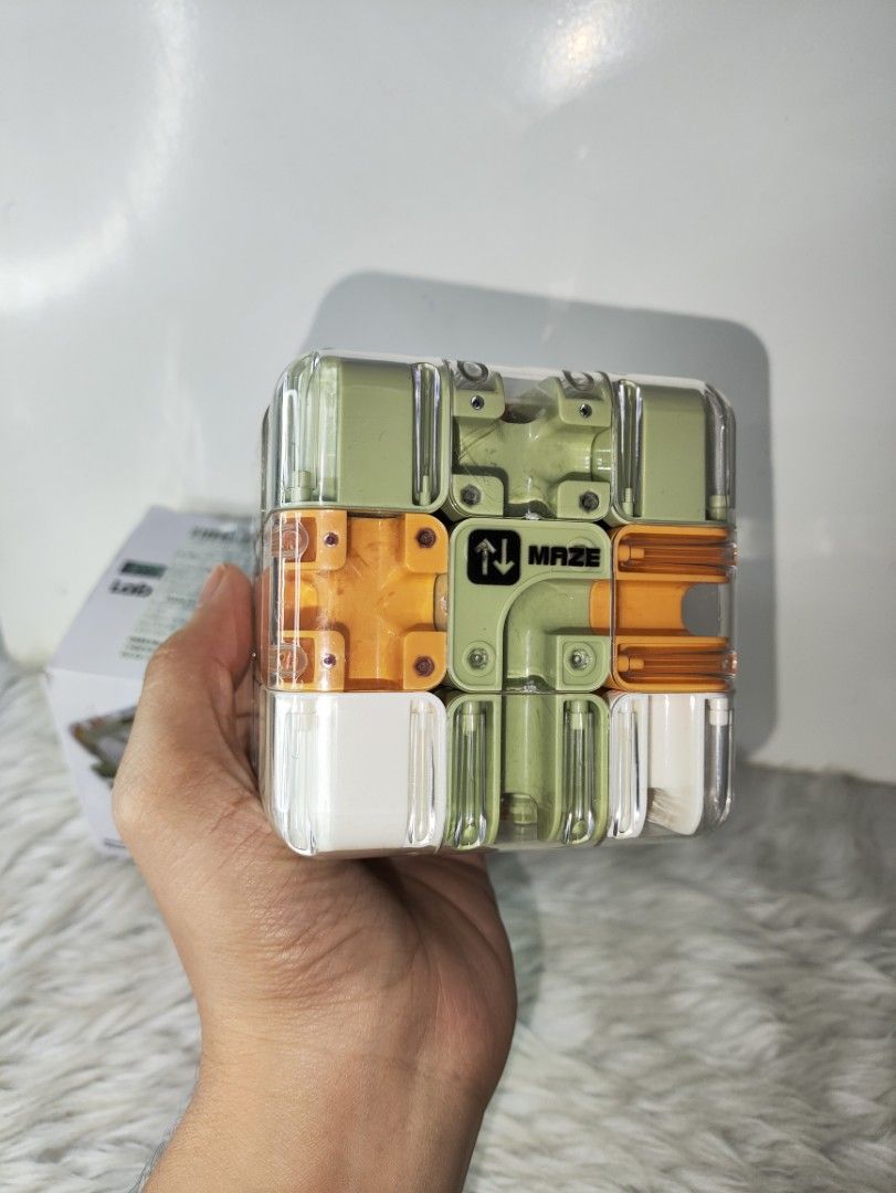 Smart Maze 3D Puzzle Cube Toy (Category: Board Games & Puzzles) located in Cavite. Submitted by tinetaclesss (Listing ID 1469498865, Image 2). Description: - Interactive smart maze puzzle cube in a sleek clear plastic housing - Features multi-colored rotating sections in white, olive green, and orange - Keeps hands busy and sharpens problem-solving skills - Suitable for kids and adults, ages 3 and up - Comes complete with its original box - great