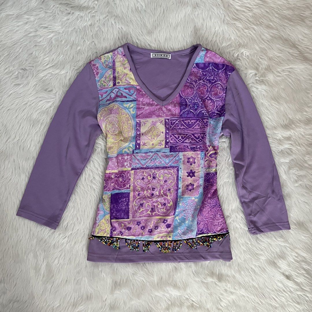 So Nice Purple Patchwork V-Neck Long Sleeve Top (Category: Longsleeves) located in Maasin. Submitted by taraa18 (Listing ID 1469546235, Image 1). Description: - Brand: So Nice - Style: Long sleeve top with V-neckline - Design: Colorful patchwork front panel in purple, yellow, and blue - Detail: Multi-colored beaded fringe along the bottom hem - Back & Sleeves: Solid purple - Condition: Excellent pre-loved condition (ready to wear).