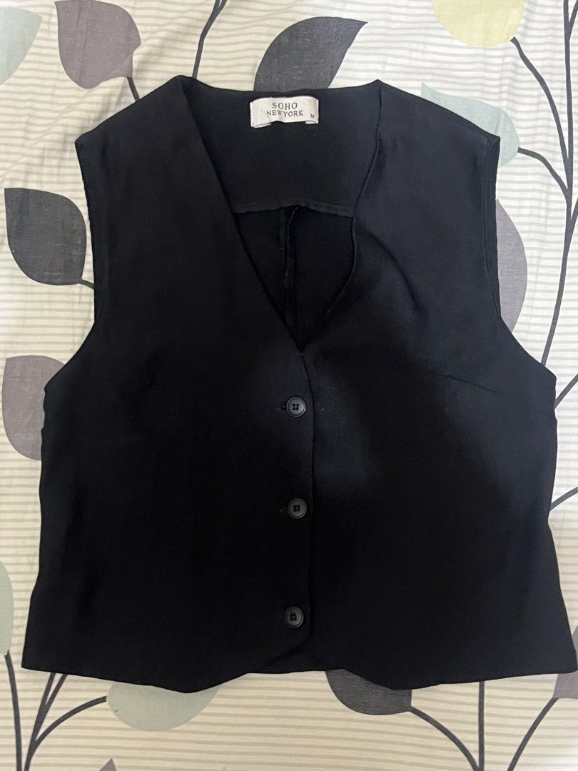 Soho New York Black Button Vest Size M (Category: Sleeveless) located in Manila. Submitted by milanamiclat (Listing ID 1469480309, Image 1). Description: - Brand: Soho New York - Size: Medium - Color: Classic black - Style: V-neck with 3 dark front buttons - Fit: Tailored, clean, and lightweight - Versatile: Great for layering over tees or button-downs.