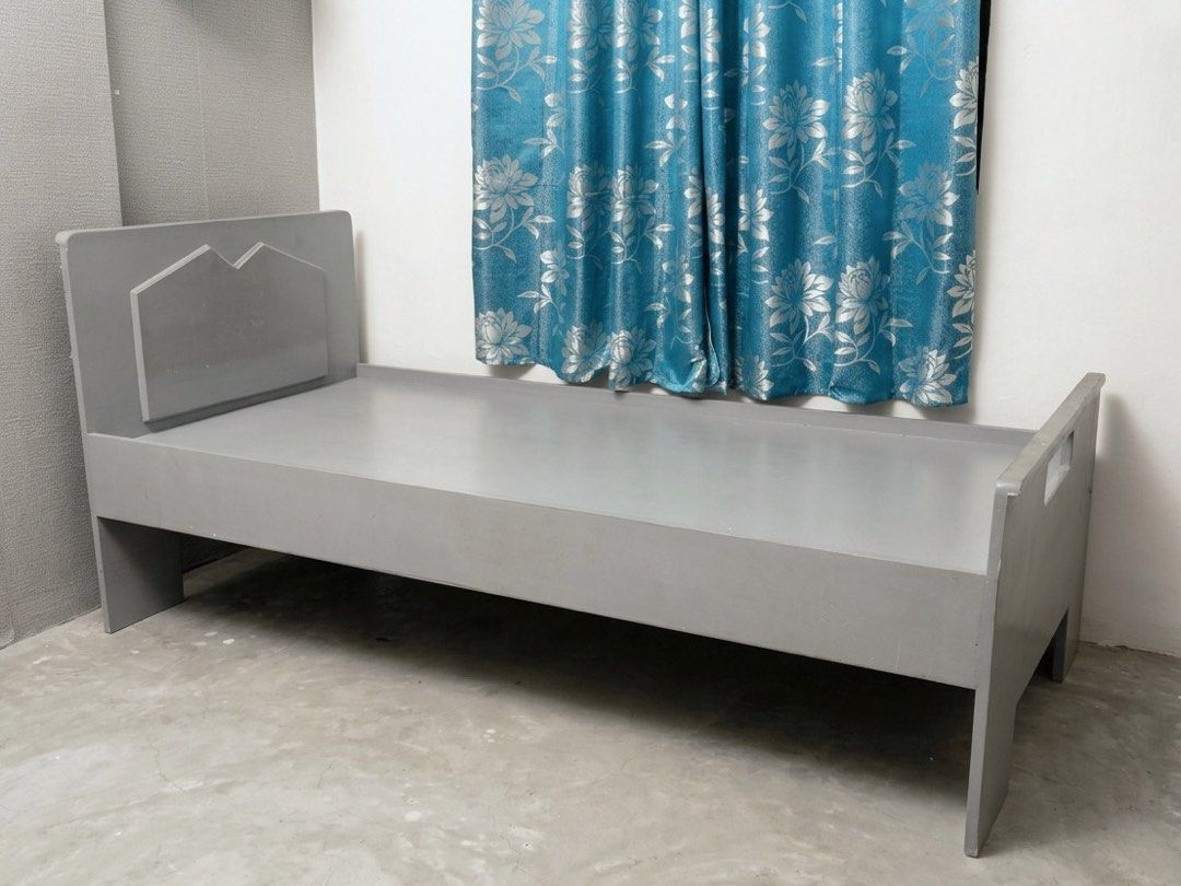 Solid Wood Single Bed Frame Grey (Category: Bed Frames & Mattresses) located in Taguig. Submitted by ccitemsss (Listing ID 1469535315, Image 1). Description: Type: Grey wooden single bed frame Design: Modern geometric headboard with a sturdy panel platform base Size: Fits a standard single mattress Condition: Pre-loved with minor signs of usage, including slight peeling/chipping of the paint in some areas. Note: The bed frame cannot be disassembl