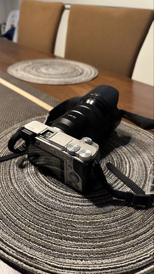 Sony A6000 Mirrorless Camera with Lens (Category: Cameras) located in Cavite. Submitted by gelocalvaran (Listing ID 1469510537, Image 3). Description: - Camera Model: Sony a6000 mirrorless camera - Lens: Sony 18-105mm f/4 G lens included - Features: Tilting LCD screen, built-in electronic viewfinder, and fully functional pop-up flash - Inclusions: Branded neck strap and lens hood - Condition: Minor cosmetic wear around strap lugs and body edges d