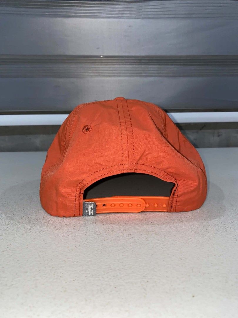 Spacecraft Orange and Cream Snapback Hat (Category: Caps & Hats) located in Baler. Submitted by mariokush193815 (Listing ID 1469452747, Image 2). Description: - Brand: Spacecraft - Style: Snapback cap in bright orange and cream corduroy - Details: Round embroidered mountain, star, and moon patch on the front - Accents: Yellow cord trim along the brim and patterned blue lining underneath - Fit: Adjustable orange plastic strap at the back - Conditi