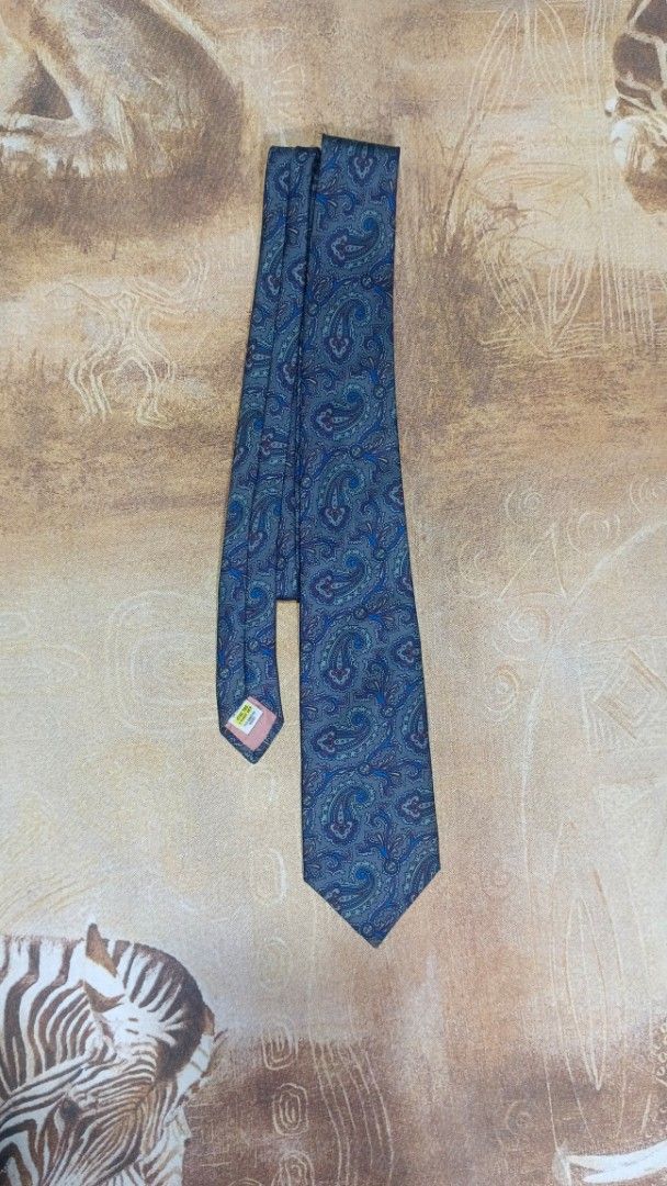 St Michael Silk Paisley Necktie Grey Blue (Category: Ties) located in Cavite. Submitted by navias (Listing ID 1469395751, Image 2). Description: Origin:UAE100% - Brand: St Michael - Material: Premium silk - Design: Detailed paisley pattern - Color: Classic grey with blue and maroon accents - Style: Standard width blade with a traditional pointed tip - Ideal for: Office wear, business meetings, and formal events Transaction Details: -via immediate