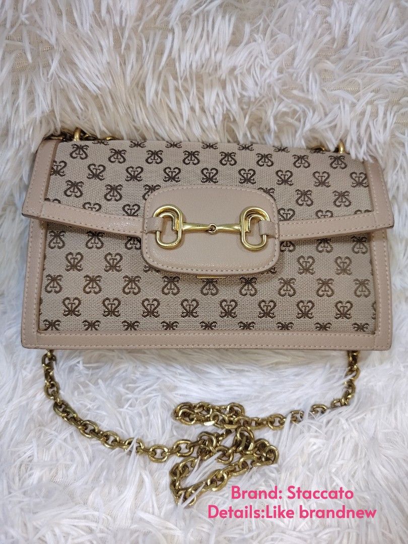 Staccato Monogram Pattern Wallet (Category: Cross-body Bags) located in Quezon City. Submitted by zhelcloset01 (Listing ID 1469320318, Image 1). Description: - Brand: Staccato - Design: All-over monogram pattern on beige fabric - Hardware: Gold-tone Staccato brand name plate - Size: Compact and pocket-friendly - Condition: Clean canvas with neat stitching.
