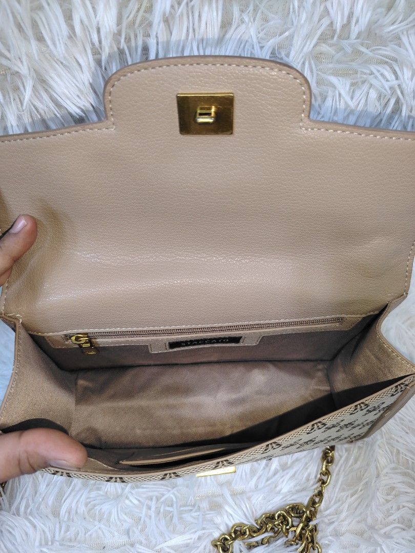 Staccato Monogram Pattern Wallet (Category: Cross-body Bags) located in Quezon City. Submitted by zhelcloset01 (Listing ID 1469320318, Image 3). Description: - Brand: Staccato - Design: All-over monogram pattern on beige fabric - Hardware: Gold-tone Staccato brand name plate - Size: Compact and pocket-friendly - Condition: Clean canvas with neat stitching.
