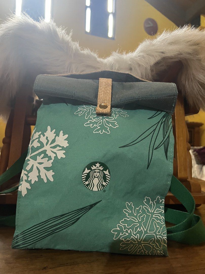 Starbucks Green Snowflake Winter Roll-Top Backpack (Category: Backpacks) located in Rizal. Submitted by safecat_3c0d85 (Listing ID 1469493590, Image 1). Description: - Brand: Starbucks - Material: Durable green canvas with white snowflake design - Closure: Dark grey roll-top with a tan woven strap and metallic snap button - Straps: Comfortable green shoulder straps - Perfect for: Daily use, school, or coffee runs during the holiday season - Condi