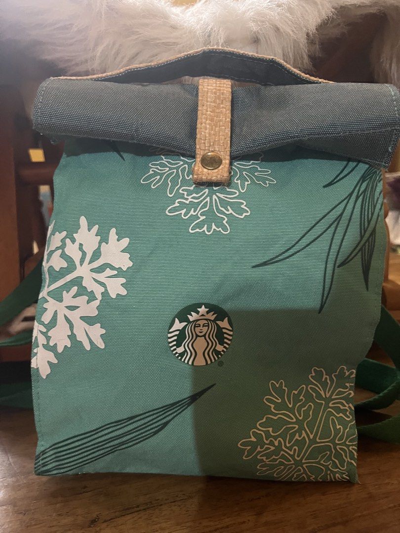 Starbucks Green Snowflake Winter Roll-Top Backpack (Category: Backpacks) located in Rizal. Submitted by safecat_3c0d85 (Listing ID 1469493590, Image 3). Description: - Brand: Starbucks - Material: Durable green canvas with white snowflake design - Closure: Dark grey roll-top with a tan woven strap and metallic snap button - Straps: Comfortable green shoulder straps - Perfect for: Daily use, school, or coffee runs during the holiday season - Condi
