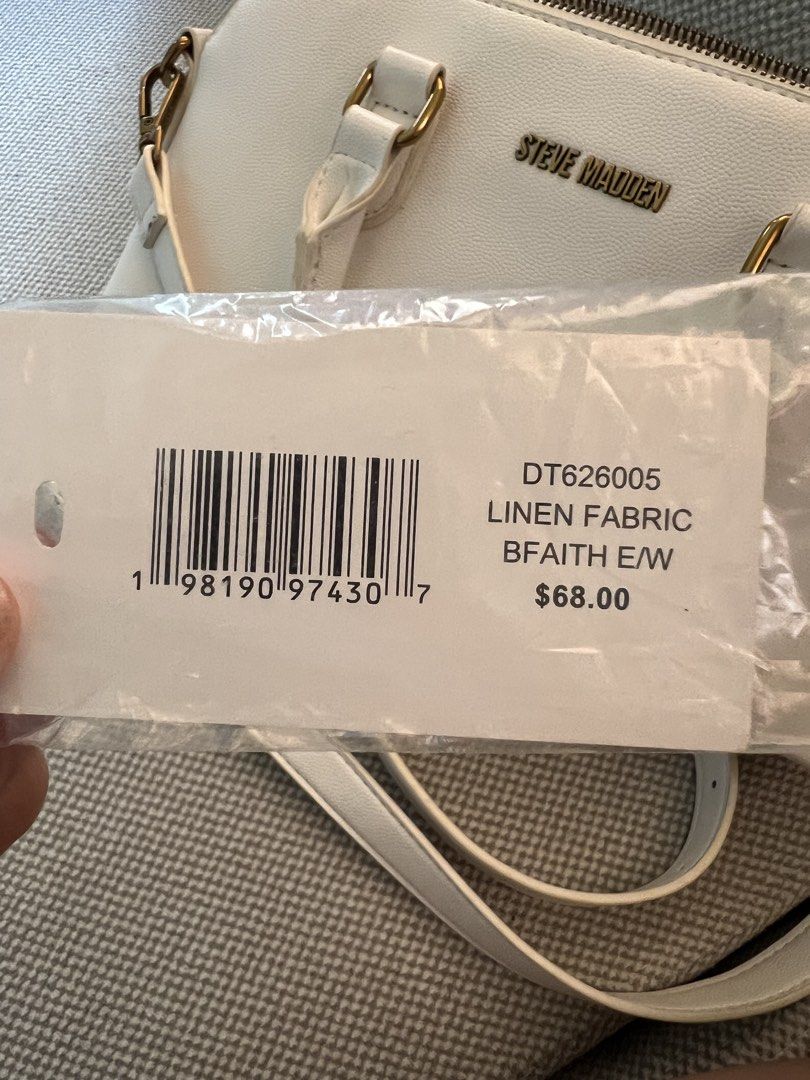 Steve Madden BFAITH E/W Crossbody Bag (Category: Cross-body Bags) located in Manila. Submitted by yiaharris215077 (Listing ID 1469474050, Image 2). Description: Steve Madden BFAITH E/W crossbody bag in white linen with gold hardware. Features dual top handles, an adjustable/removable strap.