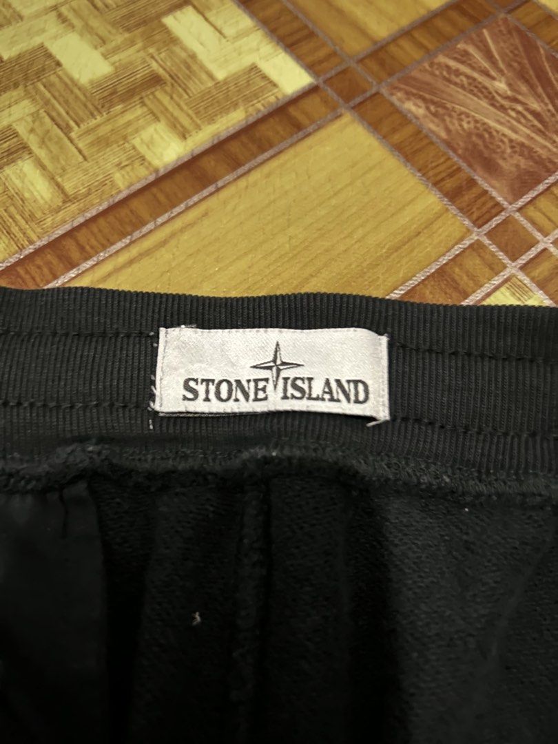 Stone Island Black Cargo Shorts (Category: Shorts) located in Manila. Submitted by garmentfinds.01 (Listing ID 1469523197, Image 2). Description: - Brand: Stone Island - Color: Black - Size: Regular fit with adjustable drawstring waist - Material: 100% Cotton, Made in Romania - Details: Signature buttoned compass patch on left leg pocket - Authenticity: Includes inner Certilogo tag - Condition: Clean, hardly worn and well-maintained.