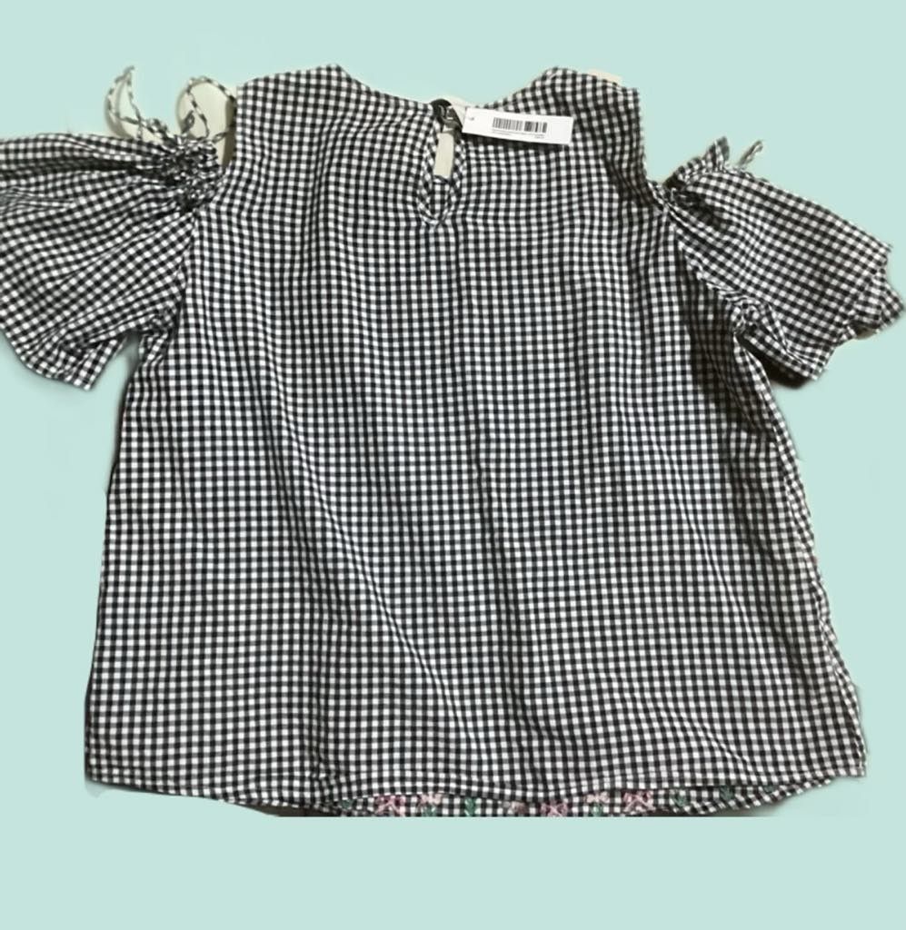 Stradivarius Black White Gingham Cold Shoulder Embroidered Blouse (Category: Blouses) located in Paranaque City. Submitted by calm_youngstore7 (Listing ID 1469402326, Image 3). Description: LAST PIECE SALE! - Brand: Stradivarius - Pattern: Black and white gingham with cute floral embroidery along the bottom hem - Design: Cold shoulder cut with trendy bow tie sleeves and back neck keyhole button closure - Fabric: Lightweight and breezy, perfect fo