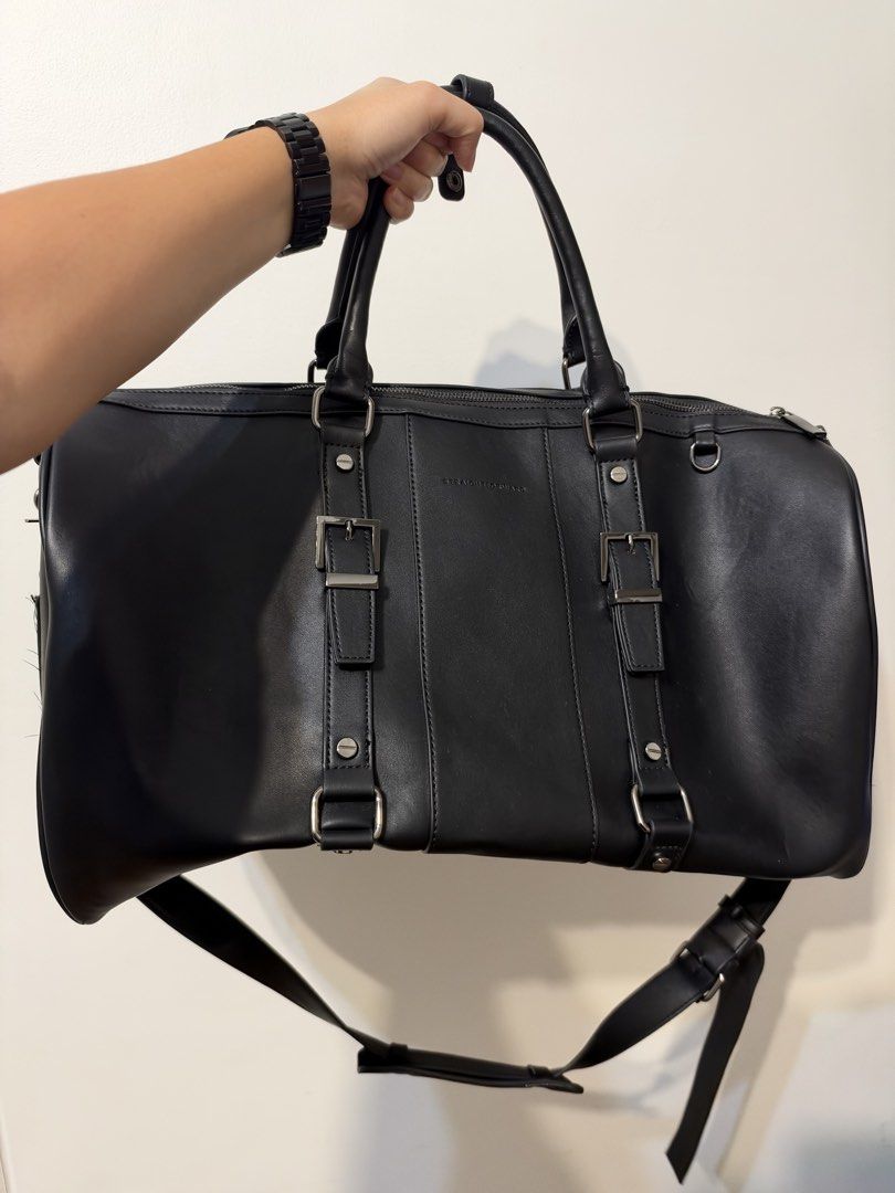 Straightforward Black Leather Travel Duffel Bag (Category: Sling Bags) located in Manila. Submitted by garagesalebykoda (Listing ID 1469511857, Image 3). Description: - Brand: Straightforward - Color: Classic Black - Material: Durable synthetic leather - Carry options: Dual top handles and adjustable shoulder strap - Design: Stylish front buckle details - Storage: Large main compartment with a secure zippered inner pocket - Condition: Clean inter