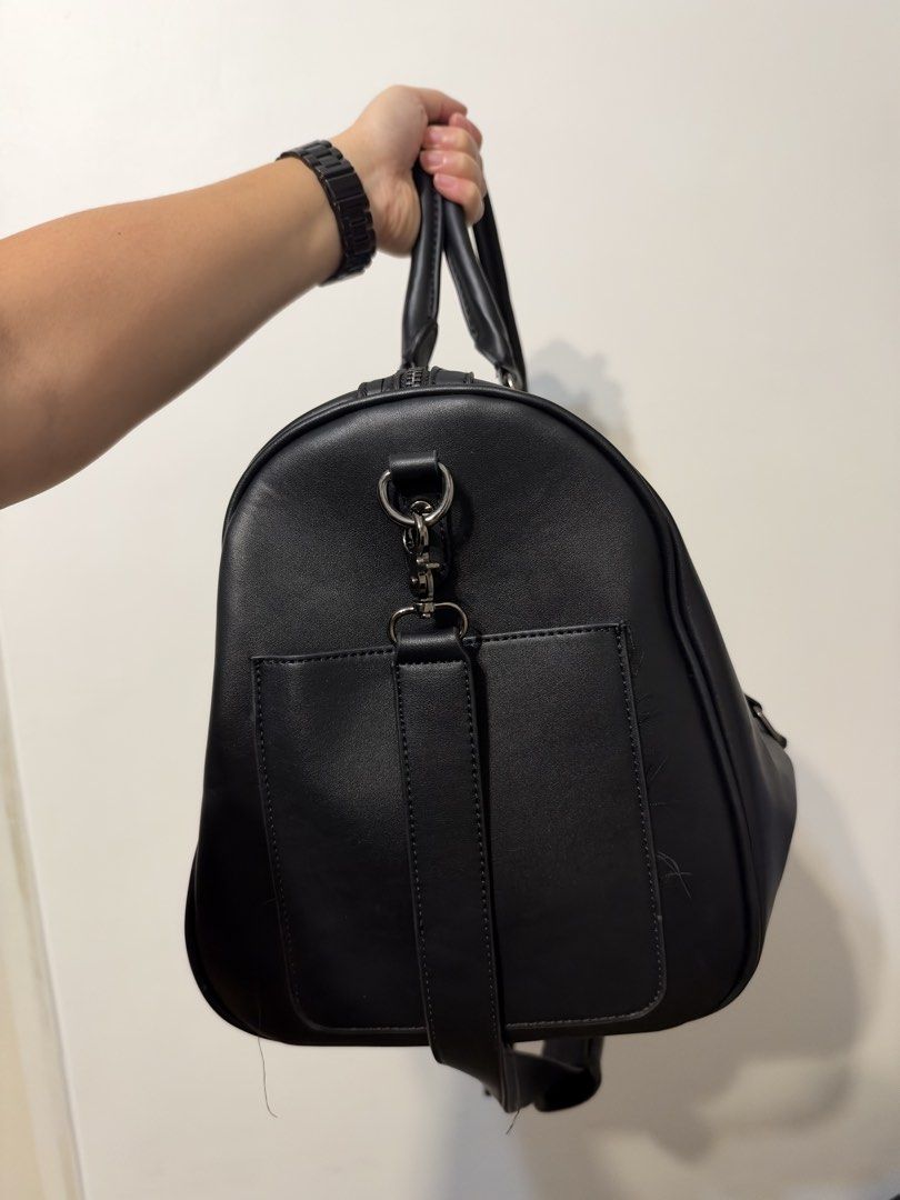 Straightforward Black Leather Travel Duffel Bag (Category: Sling Bags) located in Manila. Submitted by garagesalebykoda (Listing ID 1469511857, Image 2). Description: - Brand: Straightforward - Color: Classic Black - Material: Durable synthetic leather - Carry options: Dual top handles and adjustable shoulder strap - Design: Stylish front buckle details - Storage: Large main compartment with a secure zippered inner pocket - Condition: Clean inter