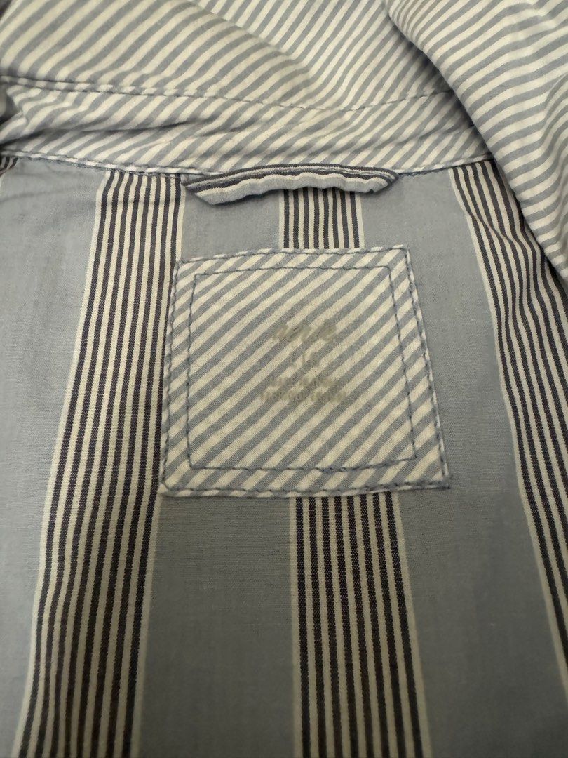 Striped button-down shirt light blue and dark blue (Category: Longsleeves) located in Taguig. Submitted by sqaumejada (Listing ID 1469413243, Image 2). Description: - Color: Light blue with dark blue and white stripes - Design: Classic collar and long sleeves with button cuffs - Fabric: Lightweight and comfortable - Versatile: Easy to pair with both jeans and trousers for a smart casual look Large on tag but fits XL-XXL oversized fit.