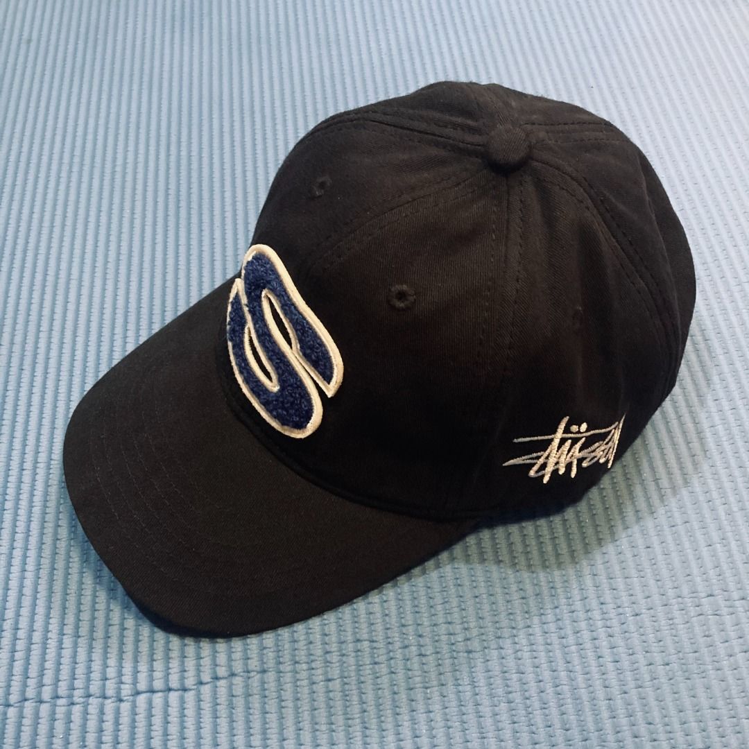Stüssy Chenille S Low Pro Cap in black. (Category: Caps & Hats) located in Rizal. Submitted by sensorix___ (Listing ID 1469432091, Image 2). Description: Stussy hits a home run with this Chenille S Low Pro Cap, stamping it with a standout Chenille "S" logo on the front. CONDITION - LIKE NEW COLOR RATE - 9 OUT OF 10 OSFA - One Size Fits all .