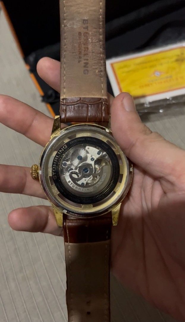 Stuhrling Dauphine 3974 Skeleton Watch (Category: Men's Watches) located in Lucena. Submitted by erniera28 (Listing ID 1469447738, Image 3). Description: - Brand: Stuhrling - Model: Dauphine 3974 - Movement: Automatic skeleton - Case Size: 48mm - Case Color: Gold-tone - Strap: Brown leather - Special Features: Skeleton dial, exhibition case back - Inclusions: Original orange and black box.