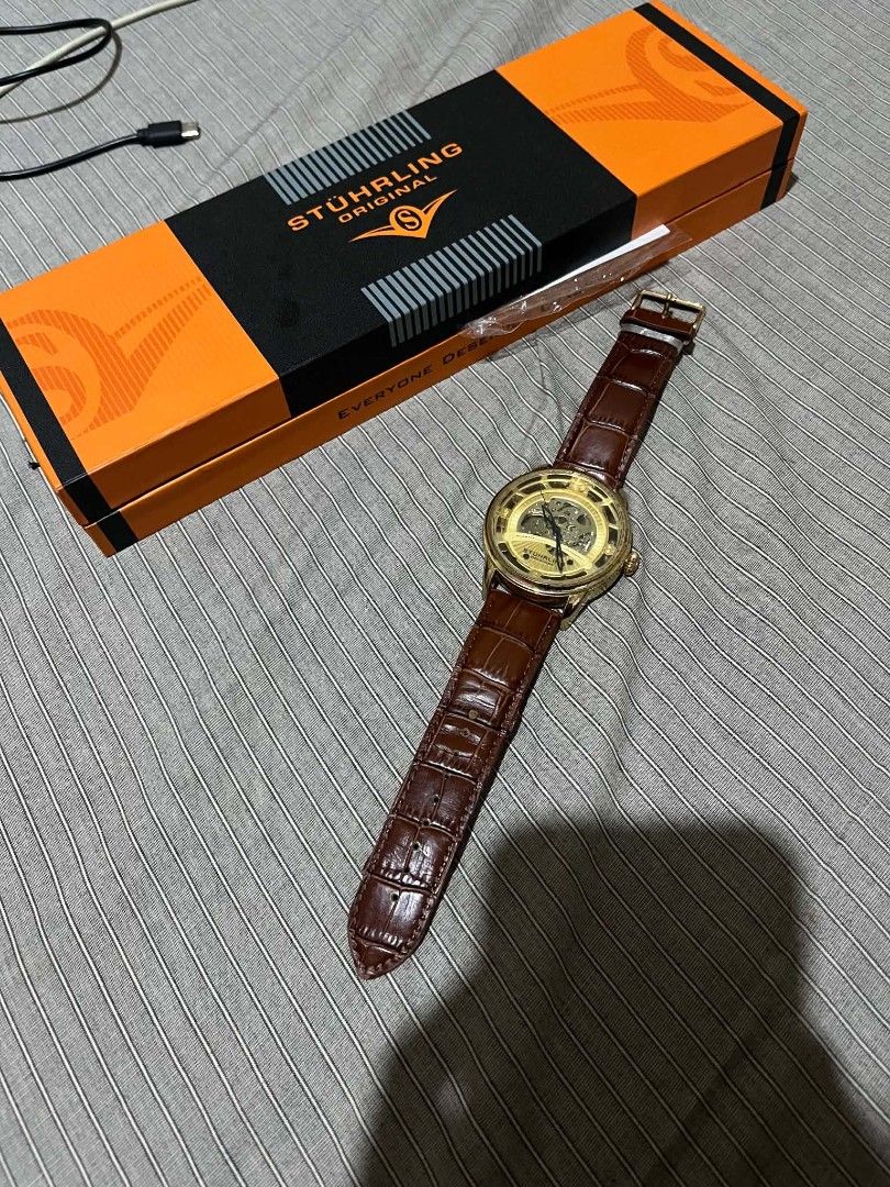 Stuhrling Dauphine 3974 Skeleton Watch (Category: Men's Watches) located in Lucena. Submitted by erniera28 (Listing ID 1469447738, Image 1). Description: - Brand: Stuhrling - Model: Dauphine 3974 - Movement: Automatic skeleton - Case Size: 48mm - Case Color: Gold-tone - Strap: Brown leather - Special Features: Skeleton dial, exhibition case back - Inclusions: Original orange and black box.