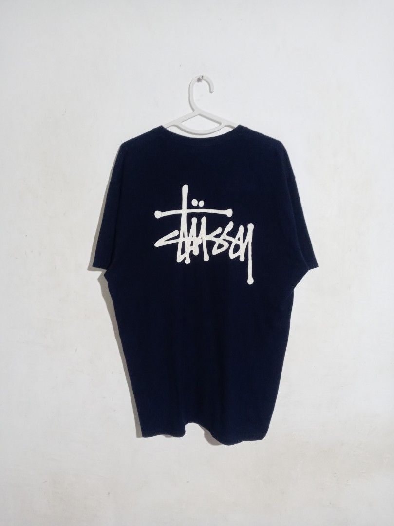 Stussy Navy Blue Logo Tee Size L (Category: Tshirts & Polo Shirts ) located in Nagcarlan. Submitted by asd0606 (Listing ID 1469503467, Image 2). Description: - Brand: Stussy - Color: Dark Navy Blue - Size: Large (tag inside collar) - Origin: Made in Mexico - Design: Small left-chest print with a large back graphic - Fit: Standard crew neck, short sleeves - Condition: Clean cotton fabric, solid everyday streetwear staple 799+sf Authenticity not gu